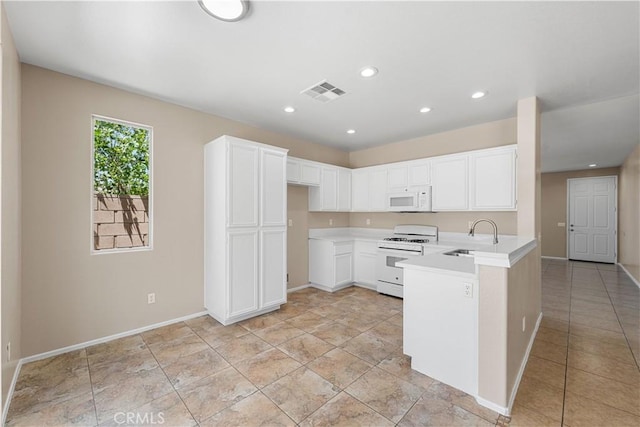 38181 Silver Ct, Palmdale, CA 93552 - kitchen with white appliances, a peninsula, light countertops, white cabinets, and recessed lighting