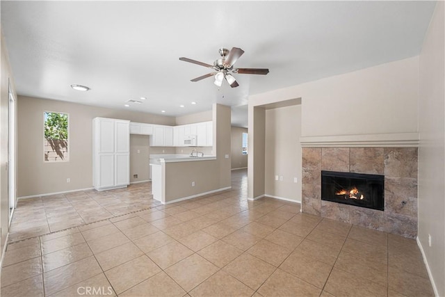 38181 Silver Ct, Palmdale, CA 93552 - unfurnished living room featuring light tile patterned flooring, a tiled fireplace, and ceiling fan