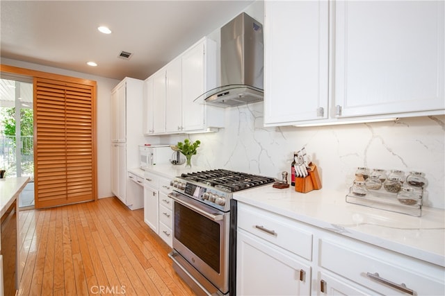 29427 Bentcreek Ct, Menifee, CA 92584 - kitchen featuring stainless steel gas range oven, island exhaust hood, backsplash, white cabinets, and recessed lighting