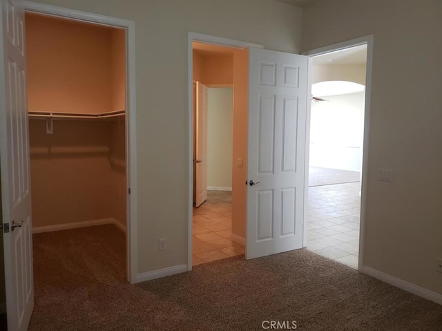 11142 Avonlea Rd, Apple Valley, CA 92308 - unfurnished bedroom with carpet floors, a spacious closet, a closet, and tile patterned flooring