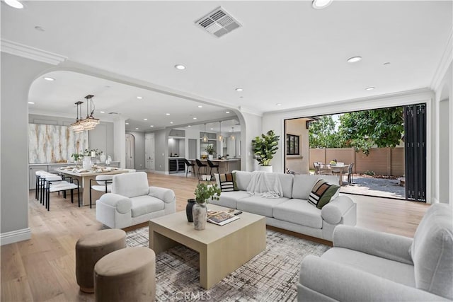 1935 S 6th Ave, Arcadia, CA 91006 - living room featuring arched walkways, light wood-style floors, crown molding, and recessed lighting