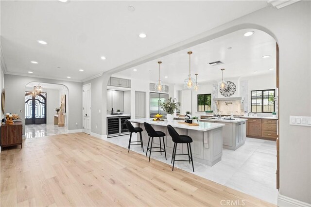 1935 S 6th Ave, Arcadia, CA 91006 - kitchen with arched walkways, high end fridge, a chandelier, a large island, and light countertops