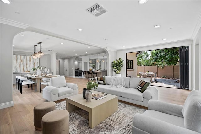 1935 S 6th Ave, Arcadia, CA 91006 - living room featuring arched walkways, light wood-type flooring, ornamental molding, and recessed lighting