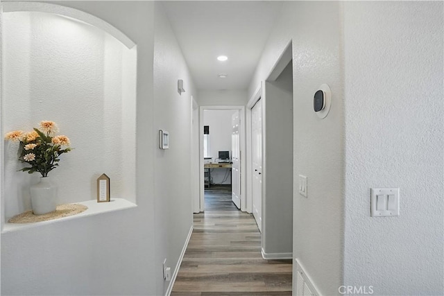 28591 Corvus Way, Menifee, CA 92586 - hallway featuring wood finished floors, recessed lighting, and arched walkways