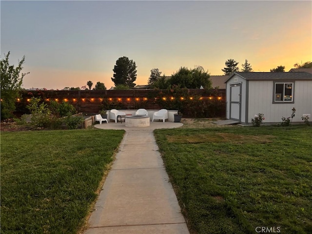 28591 Corvus Way, Menifee, CA 92586 - view of grassy yard with an outdoor fire pit, a patio, and a shed