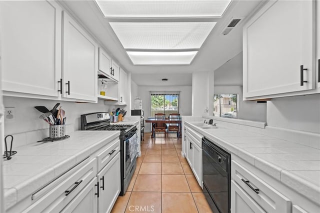 430 Anderwood Ct Unit 24, Pomona, CA 91768 - kitchen featuring stainless steel range with gas cooktop, black dishwasher, tile countertops, white cabinets, and light tile patterned floors