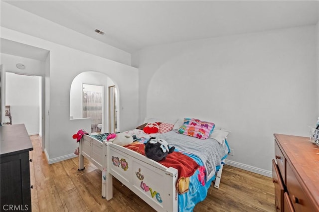 430 Anderwood Ct Unit 24, Pomona, CA 91768 - bedroom with wood finished floors, arched walkways, and vaulted ceiling