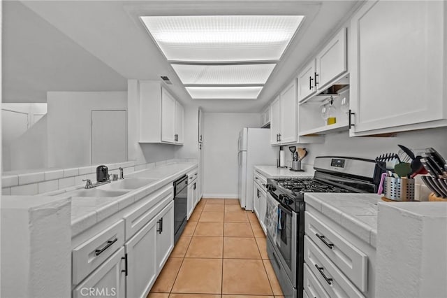 430 Anderwood Ct Unit 24, Pomona, CA 91768 - kitchen featuring gas range, tile counters, black dishwasher, and white cabinetry