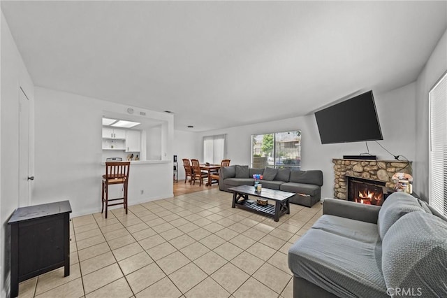 430 Anderwood Ct Unit 24, Pomona, CA 91768 - living room with light tile patterned floors and a stone fireplace