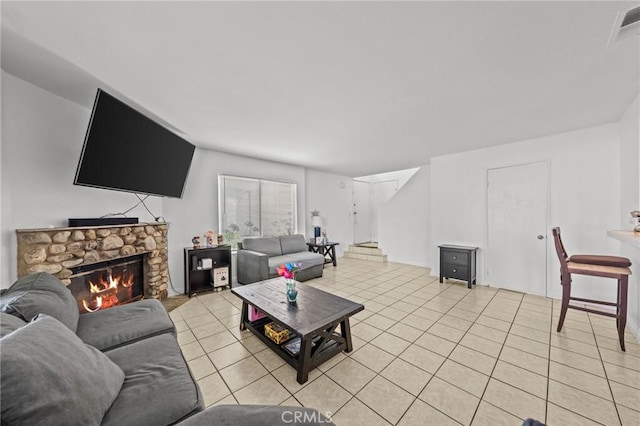 430 Anderwood Ct Unit 24, Pomona, CA 91768 - living room with light tile patterned floors, a stone fireplace, and stairs