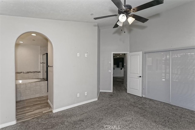12745 Autumn Leaves Ave, Victorville, CA 92395 - unfurnished bedroom featuring arched walkways, carpet flooring, ensuite bathroom, and ceiling fan