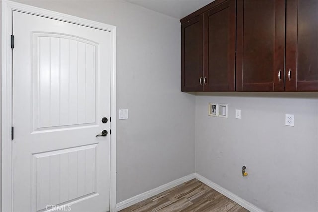12745 Autumn Leaves Ave, Victorville, CA 92395 - laundry area featuring light wood-style flooring, cabinet space, and hookup for a washing machine