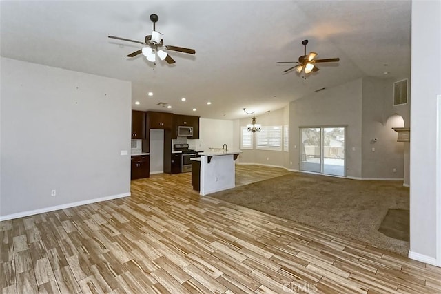 12745 Autumn Leaves Ave, Victorville, CA 92395 - kitchen with open floor plan, a ceiling fan, stainless steel appliances, light wood-style flooring, and lofted ceiling