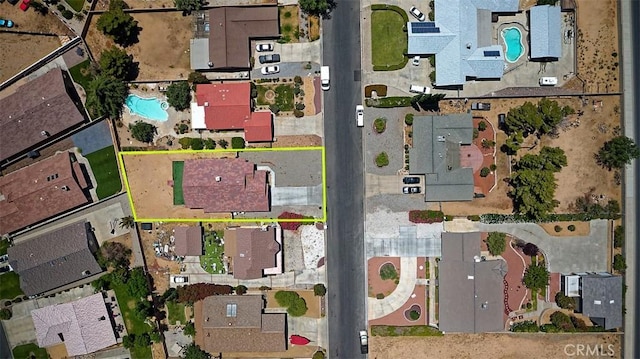 12745 Autumn Leaves Ave, Victorville, CA 92395 - aerial perspective of suburban area featuring a pool and property parcel outlined