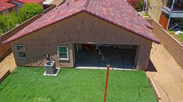 12745 Autumn Leaves Ave, Victorville, CA 92395 - rear view of property featuring a tiled roof, stucco siding, and a lawn