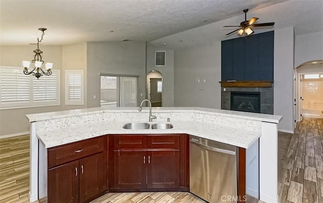 12745 Autumn Leaves Ave, Victorville, CA 92395 - kitchen with dishwasher, open floor plan, arched walkways, vaulted ceiling, and light wood-type flooring
