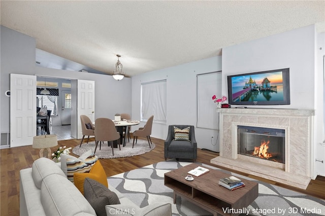 25683 Hillman Ct, Menifee, CA 92586 - living room with lofted ceiling, wood finished floors, a textured ceiling, and a high end fireplace
