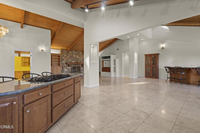 590 Alosta Dr, Camarillo, CA 93010 - kitchen featuring a wood ceiling with exposed beams, black gas stovetop, dark countertops, a fireplace, and track lighting