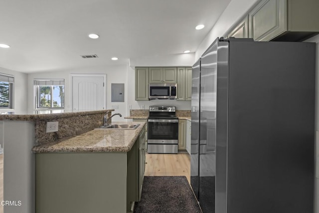 590 Alosta Dr, Camarillo, CA 93010 - kitchen with stainless steel appliances, recessed lighting, light wood-type flooring, electric panel, and a kitchen island with sink