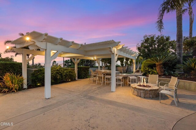 590 Alosta Dr, Camarillo, CA 93010 - patio terrace at dusk featuring an outdoor fire pit, a pergola, and a patio
