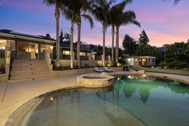 590 Alosta Dr, Camarillo, CA 93010 - pool at dusk with a patio area and a pool with connected hot tub