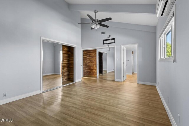 590 Alosta Dr, Camarillo, CA 93010 - unfurnished bedroom with a wall unit AC, beamed ceiling, light wood-style floors, high vaulted ceiling, and a ceiling fan