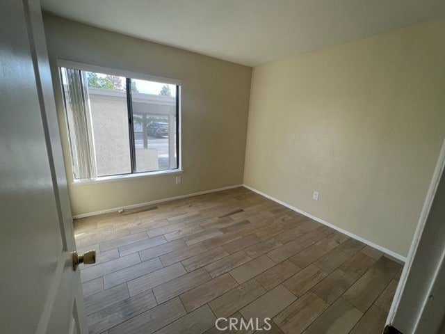 24321 El Pilar Unit 11, Laguna Niguel, CA 92677 - empty room featuring wood finished floors and baseboards