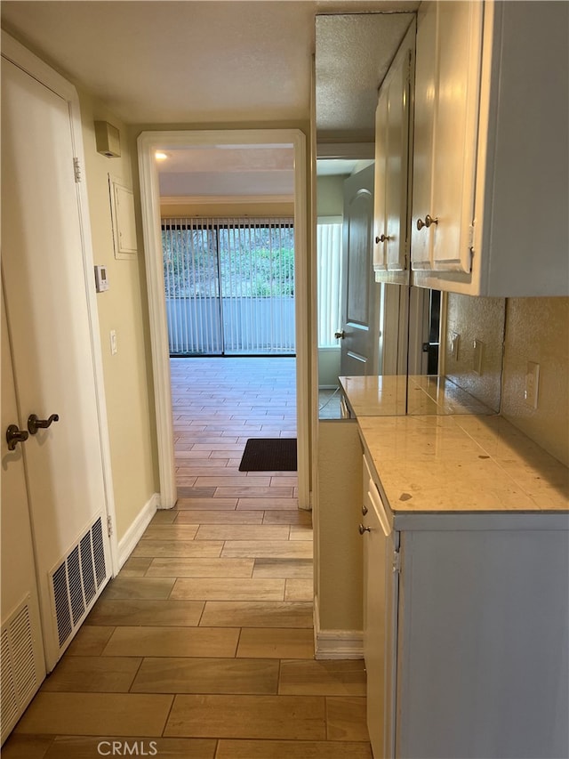 24321 El Pilar Unit 11, Laguna Niguel, CA 92677 - kitchen with wood finish floors, tasteful backsplash, and light countertops