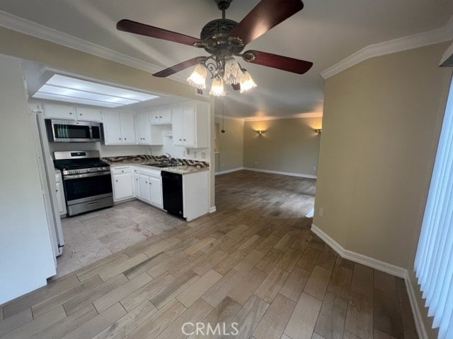 24321 El Pilar Unit 11, Laguna Niguel, CA 92677 - kitchen with stainless steel appliances, a ceiling fan, ornamental molding, light wood-type flooring, and white cabinets