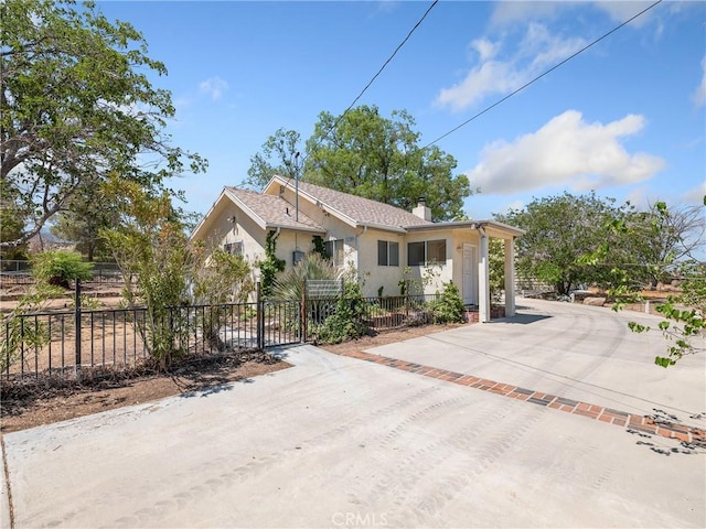 31709 213th St E, Llano, CA 93544 - view of front of house with stucco siding, a fenced front yard, a chimney, and driveway