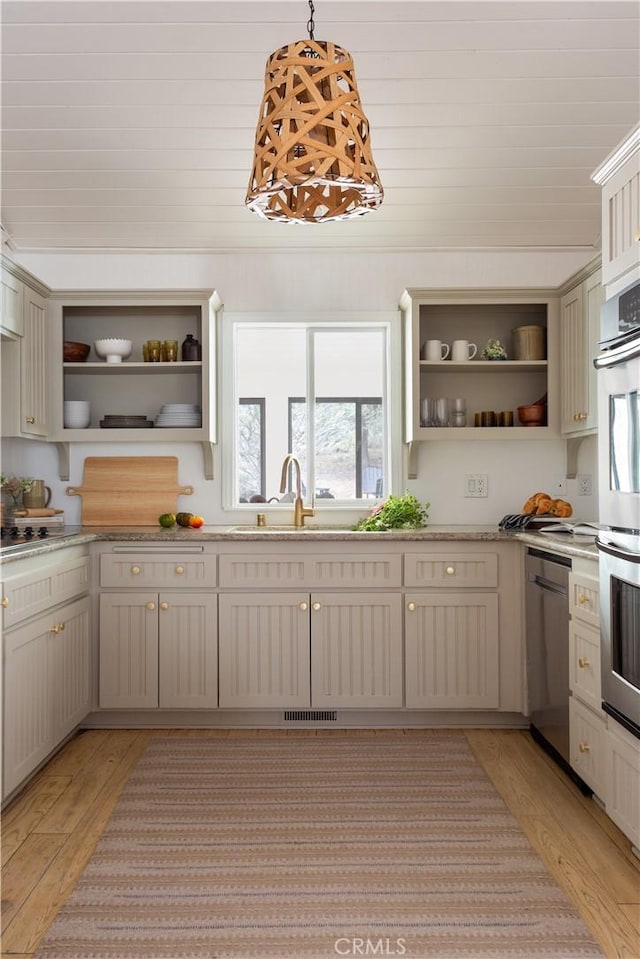 2000 Baldwin Lake Rd, Big Bear City, CA 92314 - kitchen with open shelves, stainless steel appliances, light wood finished floors, and healthy amount of natural light