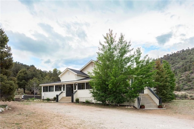 2000 Baldwin Lake Rd, Big Bear City, CA 92314 - view of front of house featuring a sunroom and stairway