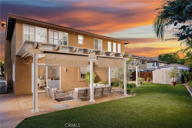 42355 Mountain View Ct, Murrieta, CA 92562 - back of house at dusk with stucco siding, a pergola, a storage unit, an outdoor hangout area, and a patio