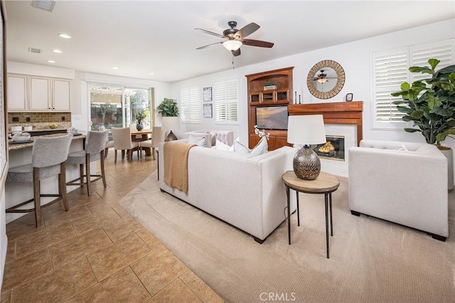 42355 Mountain View Ct, Murrieta, CA 92562 - living area with a glass covered fireplace, a ceiling fan, and recessed lighting