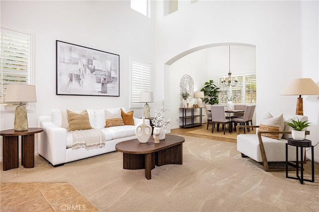 42355 Mountain View Ct, Murrieta, CA 92562 - living room featuring a chandelier, carpet, a high ceiling, and arched walkways