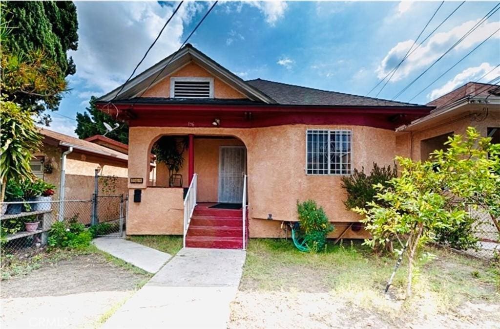 156 S Clarence St, Los Angeles, CA 90033 - view of front of property with stucco siding, covered porch, and a gate