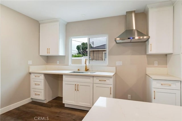 3067 Genevieve St, San Bernardino, CA 92405 - kitchen featuring wall chimney exhaust hood, dark wood finished floors, white cabinetry, and light countertops