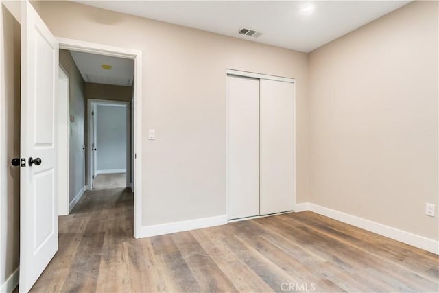 3067 Genevieve St, San Bernardino, CA 92405 - unfurnished bedroom with wood finished floors and a closet