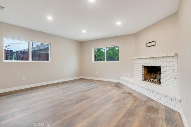 3067 Genevieve St, San Bernardino, CA 92405 - unfurnished living room featuring wood finished floors, a fireplace, and recessed lighting
