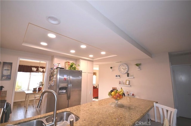 27958 Foxfire St, Menifee, CA 92586 - kitchen with stainless steel fridge with ice dispenser, a tray ceiling, recessed lighting, wood finished floors, and a peninsula