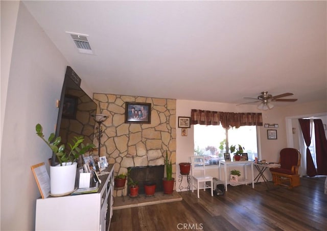 27958 Foxfire St, Menifee, CA 92586 - living area featuring wood finished floors, a stone fireplace, and ceiling fan