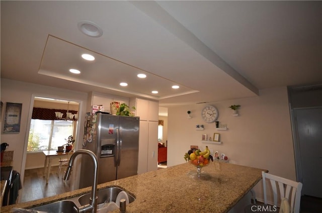 27958 Foxfire St, Menifee, CA 92586 - kitchen featuring stainless steel fridge with ice dispenser, a raised ceiling, recessed lighting, light stone countertops, and wood finished floors