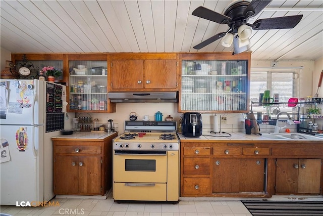 5 Dunlap, Bakersfield, CA 93309 - kitchen featuring white appliances, under cabinet range hood, tile countertops, brown cabinetry, and wooden ceiling