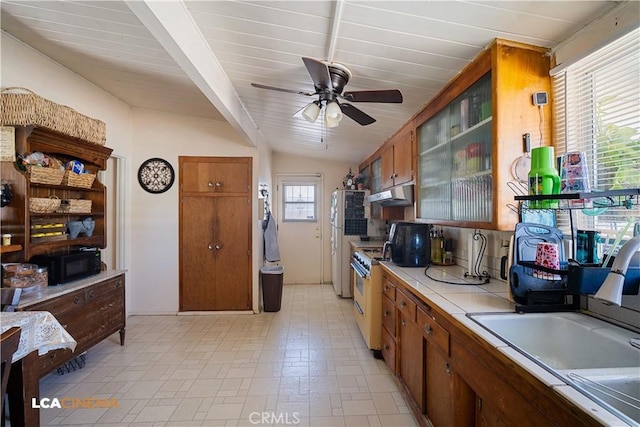 5 Dunlap, Bakersfield, CA 93309 - kitchen featuring under cabinet range hood, freestanding refrigerator, a ceiling fan, black microwave, and brown cabinetry