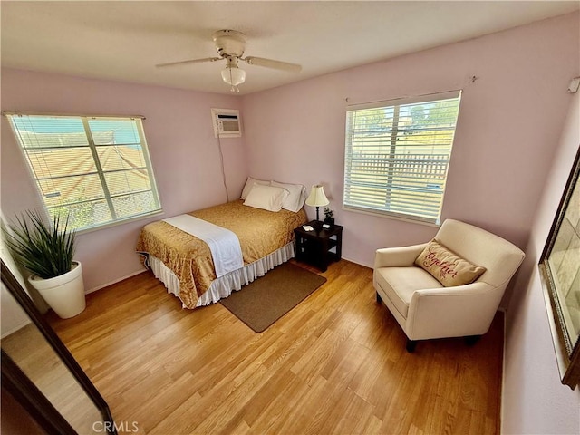 2616 N King St, Bakersfield, CA 93305 - bedroom with a wall mounted AC, light wood finished floors, and ceiling fan