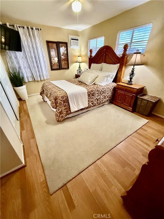 2616 N King St, Bakersfield, CA 93305 - bedroom featuring wood finished floors and a wall unit AC