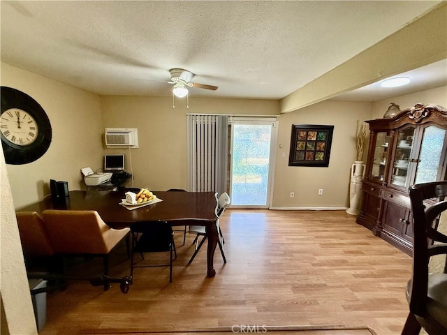 2616 N King St, Bakersfield, CA 93305 - dining space with light wood finished floors, ceiling fan, a wall mounted AC, and a textured ceiling