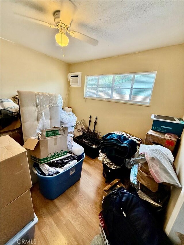 2616 N King St, Bakersfield, CA 93305 - living room featuring wood finished floors, an AC wall unit, and ceiling fan