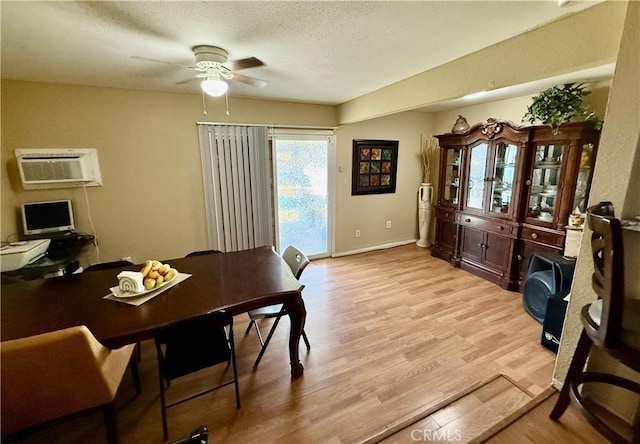 2616 N King St, Bakersfield, CA 93305 - dining area featuring a ceiling fan, an AC wall unit, light wood-style floors, and a textured ceiling
