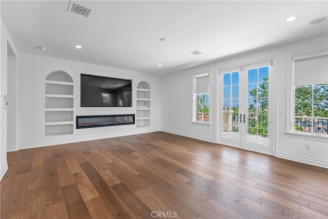 25471 Prado De Oro, Calabasas, CA 91302 - unfurnished living room with wood finished floors, built in features, a glass covered fireplace, and recessed lighting